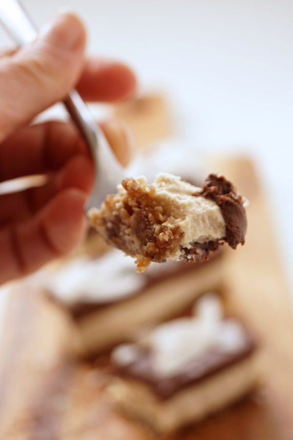 A bite of the creamy Chocolate-Coconut-Cheesecake Bars