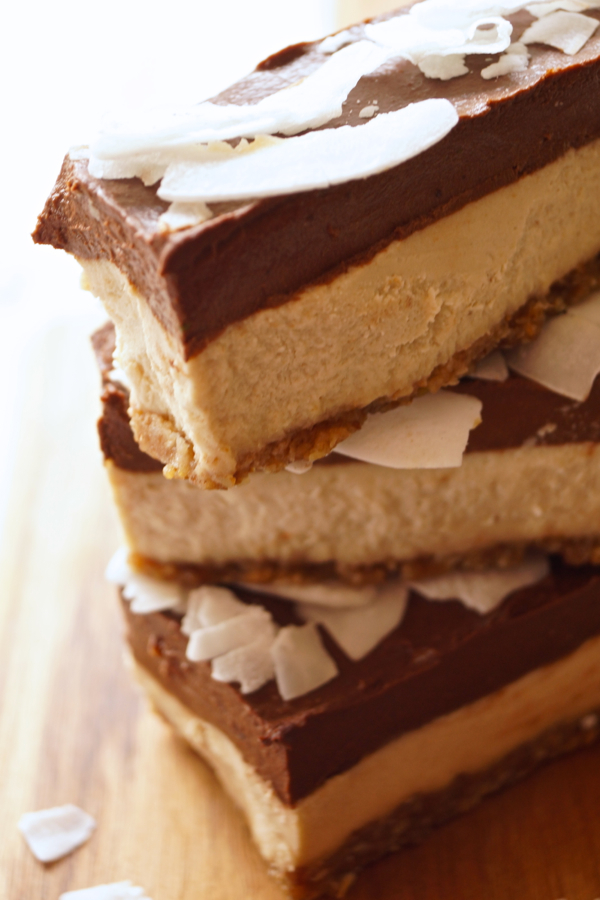 3-layer Chocolate-Coconut-Cheesecake Bars stacked on tip of each other