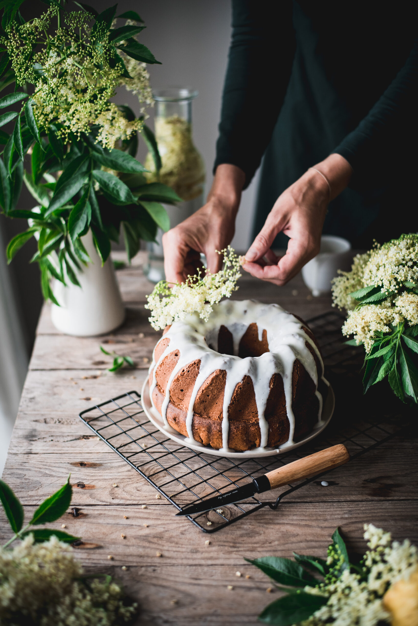 Decorating a delicious Elderflower Bundt Cake with more Elderflowers