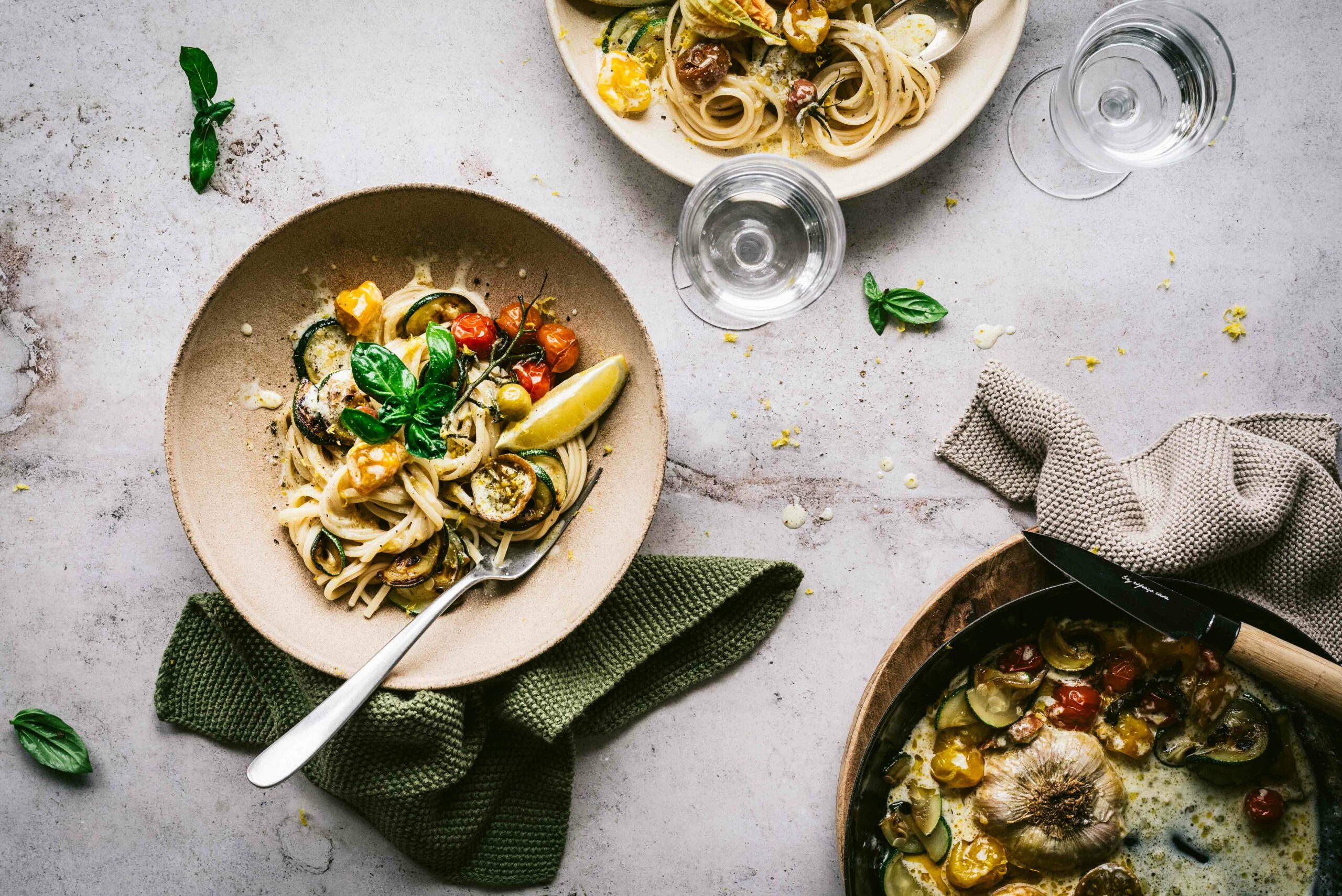 Two plates of Lemon Zucchini Tomato Pasta