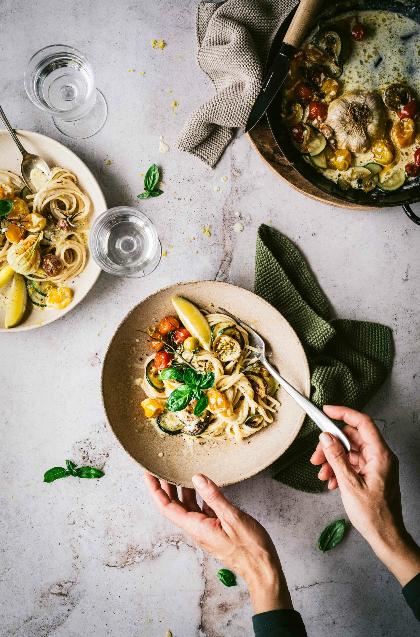 Grabing a plate of Lemon Zucchini Tomato Pasta